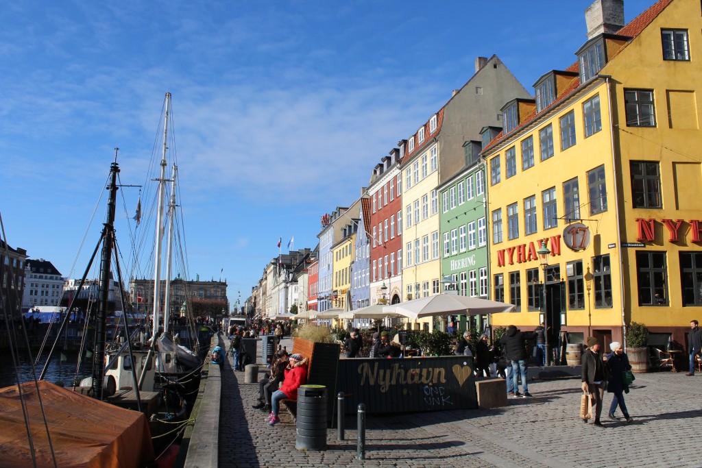 Nyhavn Sunny Side. View to safety concrete barracks as bench, flowers and climbing wall for children.